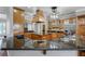 Well-equipped kitchen with stainless steel appliances, granite countertops, and custom wood cabinetry at 701 E 60 Hwy, Plant City, FL 33567