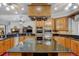 Gourmet kitchen features granite countertops, wood cabinets, island, and stainless steel appliances with open layout at 701 E 60 Hwy, Plant City, FL 33567