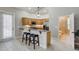 Kitchenette features granite counters, wood cabinetry, a breakfast bar, and stainless steel appliances at 701 E 60 Hwy, Plant City, FL 33567