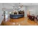 Spacious living room featuring hardwood floors, a fireplace, and a ceiling fan for comfortable living at 701 E 60 Hwy, Plant City, FL 33567