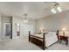 Bright main bedroom with neutral walls, ceiling fan, and ensuite bath and closet access at 701 E 60 Hwy, Plant City, FL 33567