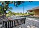 Inviting patio area with a swing, fire pit, and scenic views of the lake and well manicured yard at 701 E 60 Hwy, Plant City, FL 33567