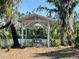 Picturesque lakeside picnic area with a shaded gazebo and seating at 701 E 60 Hwy, Plant City, FL 33567