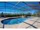 Screened-in pool featuring brick paver deck, lounge chairs, and waterfall feature at 701 E 60 Hwy, Plant City, FL 33567
