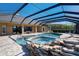 Screened-in pool area featuring a waterfall spa, in ground pool, and outdoor seating at 701 E 60 Hwy, Plant City, FL 33567