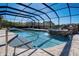 Sparkling screened-in pool with waterfall feature and brick paver deck at 701 E 60 Hwy, Plant City, FL 33567