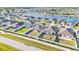 Aerial view showcases community homes with expansive backyards and picturesque lake views, perfect for outdoor living at 1009 Golden Shiner Ave, Ruskin, FL 33570