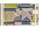 A high-angle shot showcases the roof of a home and its private backyard, enclosed by a white fence at 1009 Golden Shiner Ave, Ruskin, FL 33570
