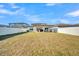Spacious backyard featuring a covered patio, lush green grass, and a privacy fence at 1009 Golden Shiner Ave, Ruskin, FL 33570