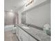 Bright bathroom featuring granite counters, a mirror, tile floors, and a shower/tub combo at 1009 Golden Shiner Ave, Ruskin, FL 33570