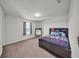 Well-lit bedroom with carpet flooring, natural light, and a comfortable bed at 1009 Golden Shiner Ave, Ruskin, FL 33570