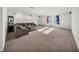 Spacious bonus room featuring modern lighting and comfortable, plush seating at 1009 Golden Shiner Ave, Ruskin, FL 33570