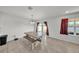 Dining area features a modern table, bench seating, and sliding glass doors at 1009 Golden Shiner Ave, Ruskin, FL 33570
