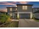 Charming two-story home with neutral siding, a two-car garage, and well-maintained landscaping at 1009 Golden Shiner Ave, Ruskin, FL 33570