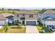 Charming two-story home with a well-manicured lawn and a two-car garage at 1009 Golden Shiner Ave, Ruskin, FL 33570