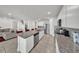 Bright kitchen boasts stainless appliances, granite counters, and island with seating at 1009 Golden Shiner Ave, Ruskin, FL 33570