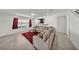 Comfortable living room with large sectional sofa, red rug, and natural light at 1009 Golden Shiner Ave, Ruskin, FL 33570
