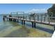 Private dock featuring a boat lift provides access to the waterfront at 1140 Boca Ciega Isle Dr, St Pete Beach, FL 33706