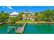 Waterfront property with a private dock and lush landscaping, perfect for enjoying coastal living at 1140 Boca Ciega Isle Dr, St Pete Beach, FL 33706