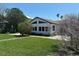 Charming home with a well-maintained front yard, mature trees, and lush green lawn at 1140 Boca Ciega Isle Dr, St Pete Beach, FL 33706