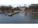 Picturesque waterfront property featuring a private dock and beautifully manicured lawn at 1140 Boca Ciega Isle Dr, St Pete Beach, FL 33706