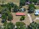 Aerial view of house with red metal roof, trees, and long driveway at 18818 Dorman Rd, Lithia, FL 33547