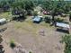 Aerial view of land with metal buildings and lush trees at 18818 Dorman Rd, Lithia, FL 33547