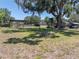 Expansive backyard featuring a pergola, treehouse, large tree, and open space at 18818 Dorman Rd, Lithia, FL 33547