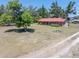 Lovely single-story house with a red roof, nestled in a green, tree-filled landscape at 18818 Dorman Rd, Lithia, FL 33547