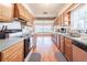 Galley kitchen featuring wooden cabinets, laminate countertops, and a view into the breakfast nook at 18818 Dorman Rd, Lithia, FL 33547