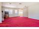 Large living room with a brick fireplace, door to the exterior, and view to the kitchen at 18818 Dorman Rd, Lithia, FL 33547