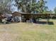 Wooden outbuilding with an attached lean-to for storage on the property at 18818 Dorman Rd, Lithia, FL 33547