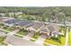 Aerial view of the homes in a suburban neighborhood with mature trees at 3134 Macintosh Rd, Land O Lakes, FL 34639