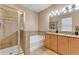 Bathroom featuring a walk-in shower, soaking tub, double vanity and neutral wall colors at 3134 Macintosh Rd, Land O Lakes, FL 34639