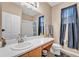 Bright bathroom with a walk-in shower featuring natural lighting and white cabinetry at 3134 Macintosh Rd, Land O Lakes, FL 34639