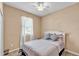 Cozy bedroom featuring natural light, a ceiling fan, and neutral wall colors at 3134 Macintosh Rd, Land O Lakes, FL 34639