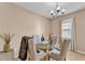 Open concept dining area with modern chandelier, glass table, and comfortable seating at 3134 Macintosh Rd, Land O Lakes, FL 34639