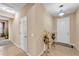 Bright foyer with neutral walls, tile flooring, and decorative flower vases at 3134 Macintosh Rd, Land O Lakes, FL 34639