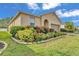Landscaped front yard with lush garden bed framing the entrance of this home at 3134 Macintosh Rd, Land O Lakes, FL 34639