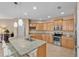 Kitchen showcasing granite counters, stainless steel appliances, and an island with a sink and breakfast bar at 3134 Macintosh Rd, Land O Lakes, FL 34639