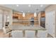 Kitchen featuring an island with granite countertops, stainless steel appliances, and a breakfast bar at 3134 Macintosh Rd, Land O Lakes, FL 34639