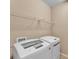 Bright laundry area featuring a full-size, white washer and dryer with storage shelf at 3134 Macintosh Rd, Land O Lakes, FL 34639