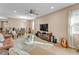 Open concept living room with tile floors, ceiling fan, and a view into the dining area at 3134 Macintosh Rd, Land O Lakes, FL 34639