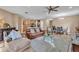 Open concept living room featuring tile floors and a view into the kitchen and dining area at 3134 Macintosh Rd, Land O Lakes, FL 34639