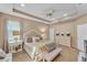 Comfortable main bedroom featuring a ceiling fan, neutral walls, and a decorative bed frame at 3134 Macintosh Rd, Land O Lakes, FL 34639