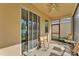 Screened-in patio with a ceiling fan and patio furniture overlooking the backyard at 3134 Macintosh Rd, Land O Lakes, FL 34639