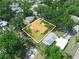 Aerial view of property within a verdant, tree-filled neighborhood, outlined in white at 115 W Lee St, Plant City, FL 33563
