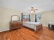 Bright bedroom featuring a window, hardwood flooring, and vintage dresser at 115 W Lee St, Plant City, FL 33563