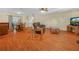 Inviting living room featuring warm wood floors, comfortable seating, and a seamless flow to the dining area at 115 W Lee St, Plant City, FL 33563