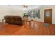 Cozy living room showcasing wood floors, comfortable seating, and an abundance of natural light at 115 W Lee St, Plant City, FL 33563